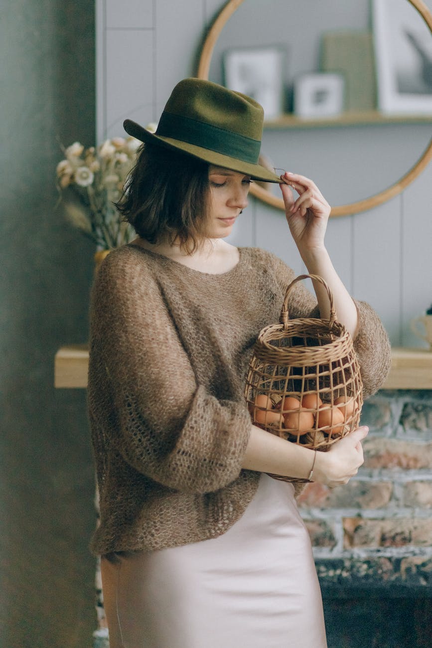 a woman holding a basket of eggs from her layer chicken